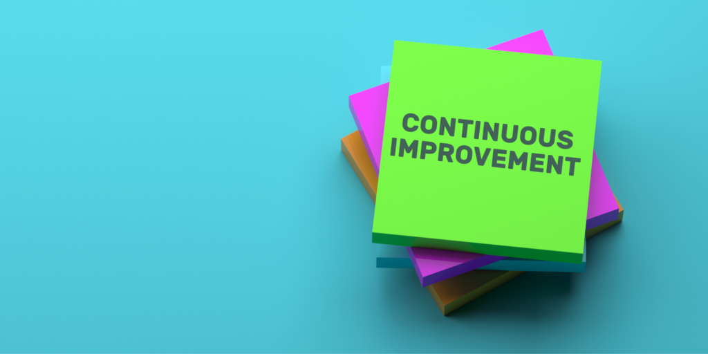 Stacked Post-Its of various colors with the phrase "Continuous Improvement" written on top.