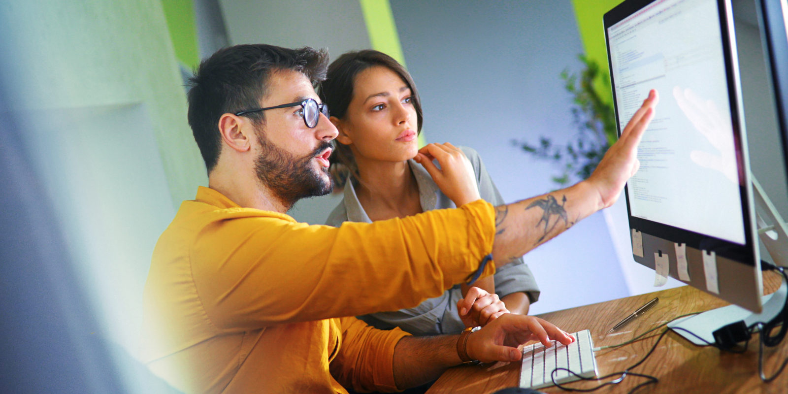 Image of two teachers doing research on a computer.